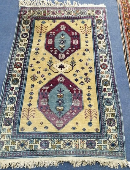 A Persian yellow ground rug with hexagons 90 x 145cm